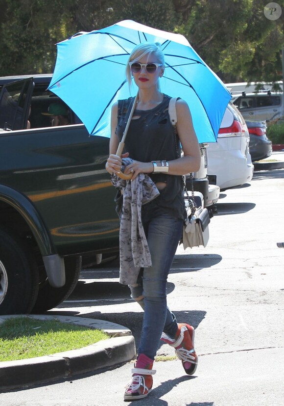 Gwen Stefani se protège du soleil avec un parapluie au cours d'une après-midi en famille aux Underwood Family Farms. Moorpark, le 6 juillet 2013.