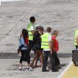 EXCLU - Laeticia Hallyday, ses filles Jade et Joy, sa grand-mère Eliette et la nounou arrivent a l'aéroport de Saint Barthelemy pour leurs vacances d'été alors que Johnny est en tournage à Saint-Gervais sur le dernier film de Claude Lelouch 'Salaud on t'aime', le 22 juillet 2013.