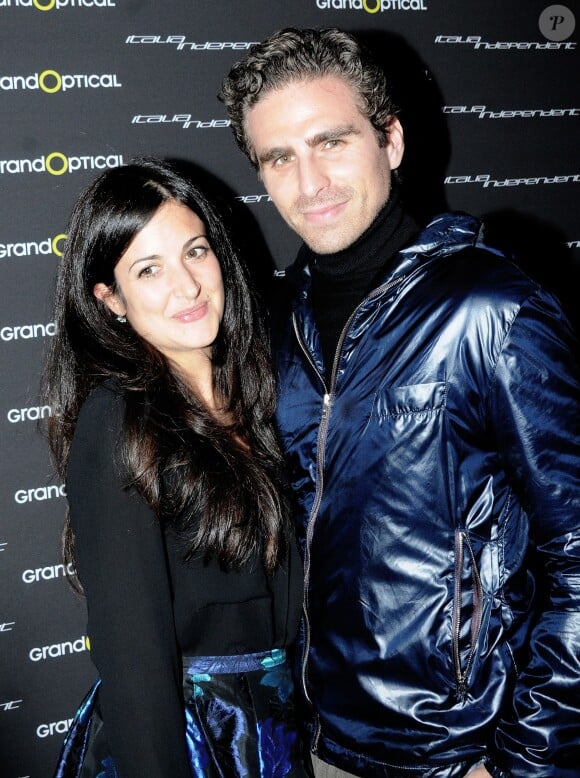 Andrea Pallaoro et une amie lors du cocktail Italia Independent (marque de Lapo Elkann) au Grand Optical des Champs-Elysées le 12 décembre 2013.