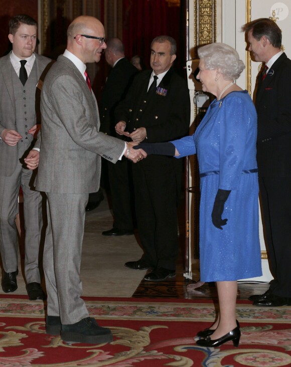 Harry Hill salué par la reine Elizabeth II lors de la réception organisée le 17 février 2014 à Buckingham Palace pour célébrer les soixante ans du patronage de la Royal Academy of Dramatic Art par la reine Elizabeth II.
