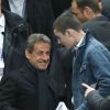 Nicolas Sarkozy et son fils Louis lors de la finale de football de la Coupe de la Ligue, PSG - Lyon (2-1), au Stade de France à Paris. Le 19 avril 2014.