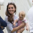 Kate Middleton, la duchesse de Cambridge et son fils le prince George encouragent le prince William et le prince Harry lors du match d'un polo à Windsor, le 15 juin 2014.