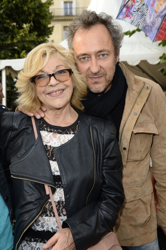 Nicoletta et son mari Jean-Christophe participent à l'ouverture de la fête des Tuileries 2014 à Paris, le 27 juin 2014.