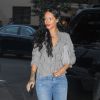 Rihanna quitte le restaurant Da Silvano à New York, habillée d'une chemise rayée Isabel Marant Etoile, d'une pochette Miu Miu, d'un jean Citizens of Humanity et de sandales Manolo Blahnik (modèle Chaos). Le 31 juillet 2014.