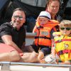Elton John, son compagnon David Furnish et leurs fils Elijah et Zachary sur le yacht de Lily Safra dans le port de Saint-Tropez, le 19 août 2014