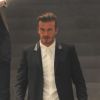 David Beckham sort de la nouvelle boutique Victoria Beckham, le jour de son ouverture, à Londres, le 25 septembre 2014. 