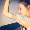 Vanessa Lawrens dévoile son nouveau tatouage placé à l'intérieur du bras. Celui-ci est composé de nombres romains. Octobre 2014.