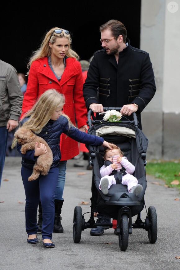 Michelle Hunziker, enceinte, et Tomaso Trussardi, qui se sont mariés la veille, se promènent avec leur fille Sole à Bergame, le 11 octobre 2014.
