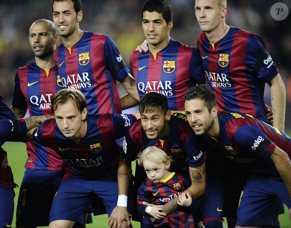 Neymar Da Silva Santos Junior pose avec son fils Davi Lucca da Silva Santos et les autres joueurs avant le match du FC Barcelone contre le RC Celta de Vigo au Camp Nou à Barcelone, le 1er novembre 2014