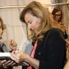 Exclusif - Valérie Trierweiler signe un exemplaire de son livre "Merci pour ce moment" dans les coulisses du défilé Paul & Joe, au Palais de Tokyo. Paris, le 30 septembre 2014.
