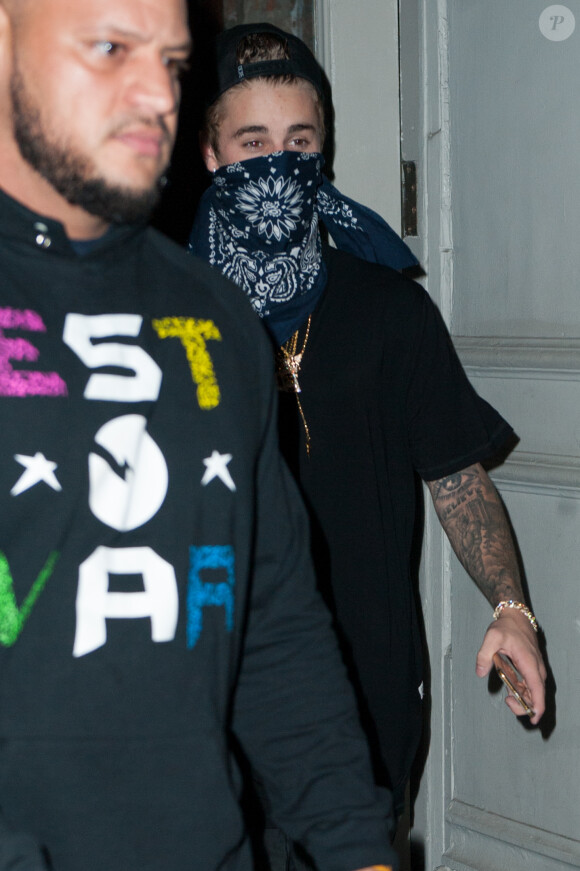 Justin Bieber sort avec un bandana sur le visage à New York, le 27 novembre 2014. 