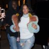 Rihanna passe aux boutiques L'Eclaireur et Market Montaigne à Paris, habillée d'une veste en fourrure MaryMe-JimmyPaul, un débardeur blanc à col roulé, un jean craqué et des sandales Dsquared² (pré-collection automne 2015). Le 7 mars 2015.