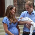  Kate Middleton et le prince William pr&eacute;sentant le prince George de Cambridge devant la maternit&eacute; de l'h&ocirc;pital St Mary, le 23 juillet 2013, au lendemain de sa naissance. 