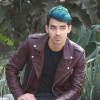 Joe Jonas, les cheveux bleus, se promène et discute avec un ami dans les rues de Los Angeles, le 24 novembre 2015