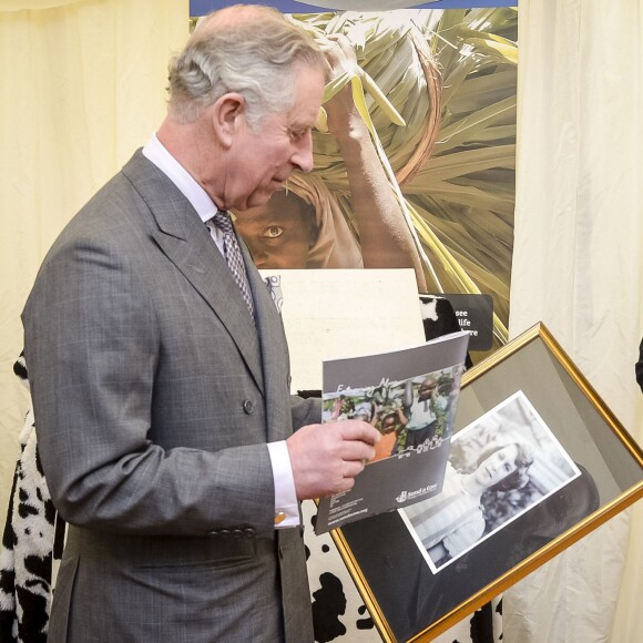 Le prince Charles découvre une photo de sa mère la reine Elizabeth II prise en 1939 lorsqu'elle avait 13 ans par Lawrence Audrain, lors d'une visite à l'association Send a Cow dont il est le président à Bath le 1er février 2016.