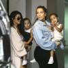 Kourtney Kardashian avec sa fille Penelope Disick et Kim Kardashian avec son mari Kanye West et leur fille North West - La famille Kardashian se promène dans les rues de Miami, le 24 avril 2016