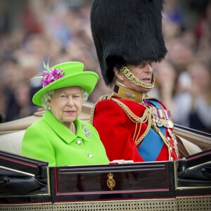 La reine Elizabeth II (dans un ensemble Stewart Parvin) et le prince Philip, duc d'Edimbourg, dans le Carrosse de la Reine découvert au cours de la procession sur le Mall lors de la parade Trooping the Colour, le 11 juin 2016 à Londres, en l'honneur du 90e anniversaire de la souveraine.