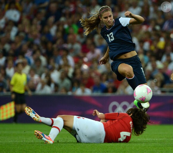 USA's Alex Morgan (13) jumps over Japan's Saki Kumagai (4) in the second half of the women's soccer final at Wembley Stadium in London, UK, in the Summer Olympic Games on Thursday, August 9, 2012. The U.S. defeated Japan, 2-1, for the gold medal. Photo by Nhat V. Meyer/San Jose Mercury News/MCT/ABACAPRESS.COM10/08/2012 - London