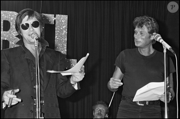 Jacques Dutronc et Johnny Hallyday chantent ensemble lors de l'émission de RTL "Rock'n'Roll Circus", Paris, 1984.