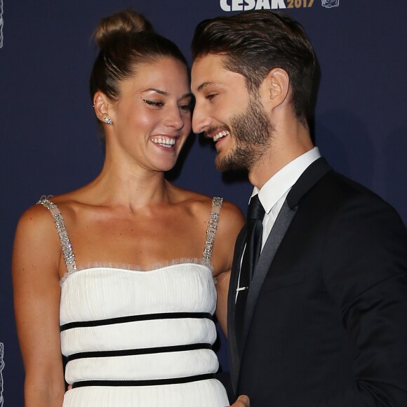 Pierre Niney (Smoking Dior, chaussures Louboutin, Bijoux Montblanc) et sa compagne Natasha Andrews (Robe Dior, chaussures Louboutin, bijoux Cartier) - Photocall de la 42ème cérémonie des Cesar à la salle Pleyel à Paris, le 24 février 2017. © Dominique Jacovides - Olivier Borde / Bestimage