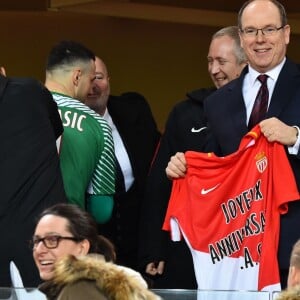 De gauche à droite, Vadim Vasilyev, le vice président de l'AS Monaco, le prince Albert II de Monaco et Louis Ducruet durant la rencontre de football de Ligue 1 opposant Monaco à Lille au stade Louis II le 16 mars 2018. Le prince Albert II de Monaco qui célébrait ses 60 ans le 14 mars, a eu comme premier cadeau la victoire de son club et à la fin de la rencontre les joueurs lui ont offert un ballon et un maillot floqué du texte : Joyeux Anniversaire SAS. © Bruno Bebert/Bestimage