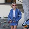 Exclusif - Hailey Baldwin se balade dans un ensemble veste et jupe en jean Adidas à Los Angeles, Californie, Etats-Unis, le 26 mars 2018.