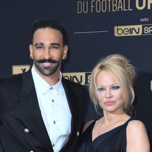 Adil Rami et sa compagne Pamela Anderson au photocall de la 28ème cérémonie des trophées UNFP (Union nationale des footballeurs professionnels) au Pavillon d'Armenonville à Paris, France, le 19 mai 2019. © Coadic Guirec/Bestimage