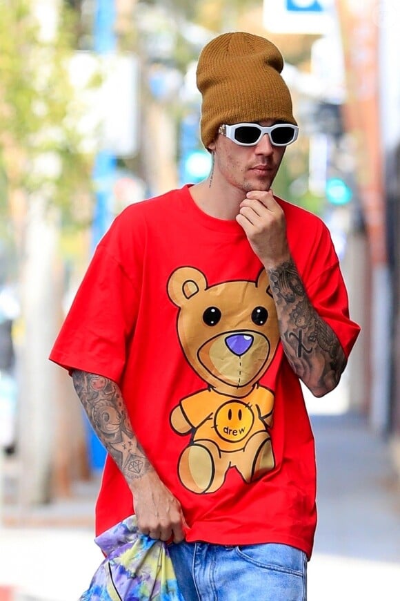 Justin Bieber porte un t-shirt Drew de sa propre marque, un bonnet de laine et des lunettes de soleil blanches à son arrivée dans un immeuble dans le quartier de West Hollywood à Los Angeles, le 1er septembre 2019
