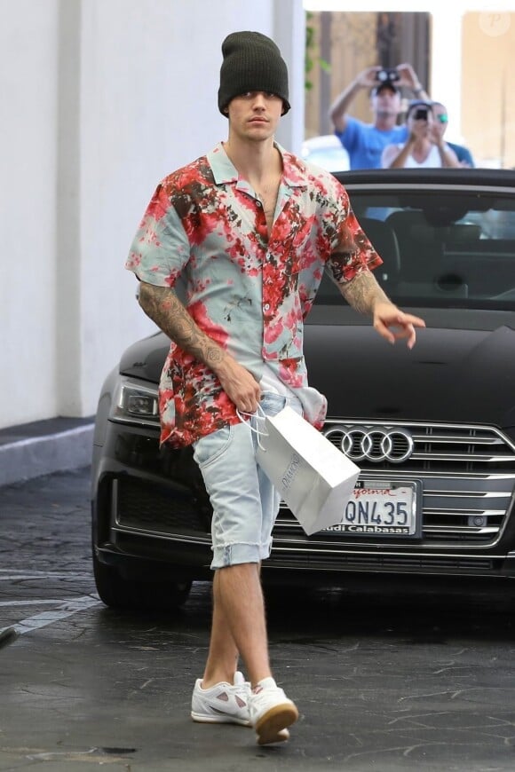 Justin Bieber fait le signe des rappeurs à la sortie de bureaux du quartier de Beverly Hills avec sa femme H.Baldwin Bieber à Los Angeles, le 29 août 2019