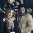 Maxim Nucci et sa compagne Isabelle Ithurburu enceinte assistent au huitième de finale retour de Ligue des Champion, du Paris Saint-Germain contre le Real Madrid au Parc des Princes à Paris le 6 mars 2018. © Cyril Moreau/Bestimage