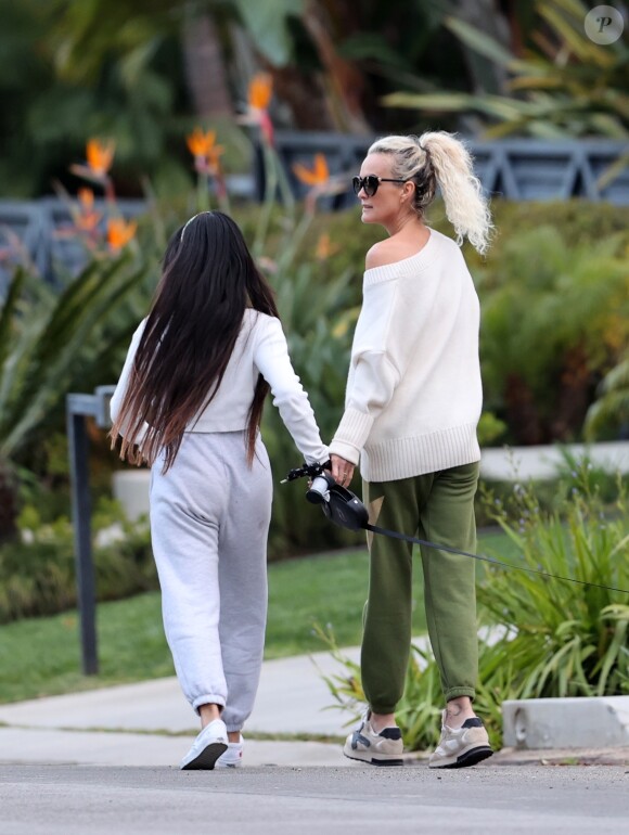 Laeticia Hallyday et ses filles Jade, 15 ans, et Joy, 11 ans, promènent leur chien Cheyenne dans le quartier de Brentwood à Los Angeles, pendant la période de confinement liée à l'épidémie de coronavirus (Covid-19), le 1er avril 2020.