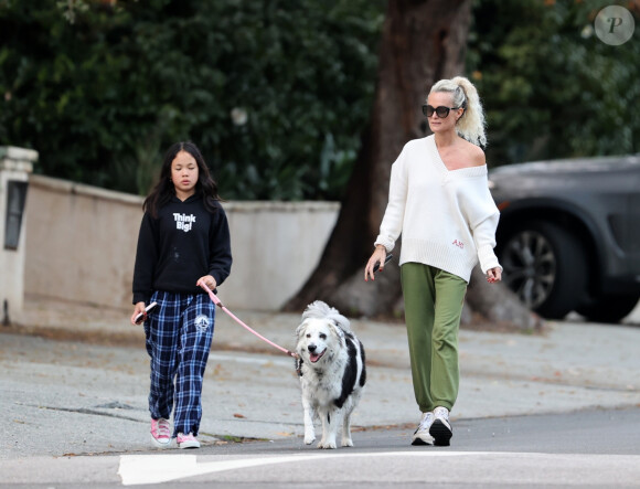 Laeticia Hallyday et ses filles Jade, 15 ans, et Joy, 11 ans, promènent leur chien Cheyenne dans le quartier de Brentwood à Los Angeles, pendant la période de confinement liée à l'épidémie de coronavirus (Covid-19), le 1er avril 2020.