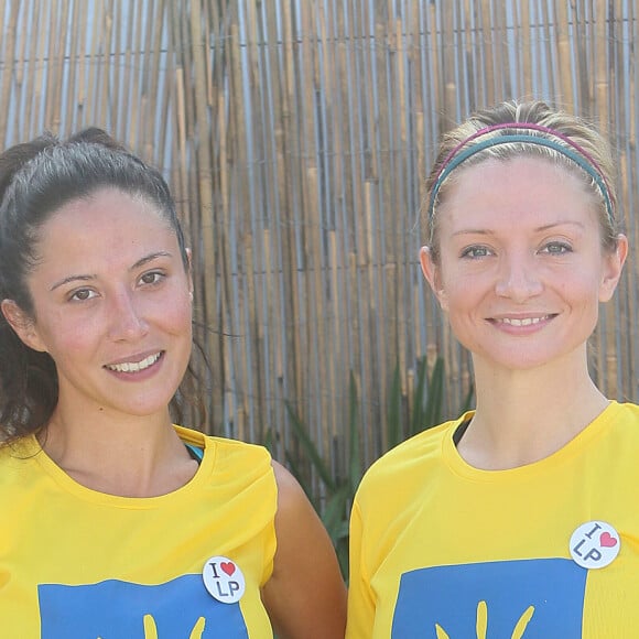 Fabienne Carat et sa soeur Carole lors de la course "La Parisienne 2014" au Champs de Mars à Paris, le 14 septembre 2014.