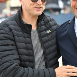 Guillaume Canet (arbore la moustache d'Astérix pour les besoins de son rôle dans "Astérix et Obélix: L'Empire du milieu") - Les personnalités assistent au Longines Paris Eiffel Jumping au Champ de Mars, le 27 juin 2021. © Veeren / Bestimage 