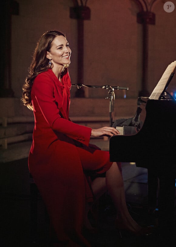 Catherine (Kate) Middleton, duchesse de Cambridge, accompagne au piano Tom Walker, qui chante "For Those Who Can't Be Here", dans l'abbaye de Westminster, dans le cadre de l'enregistrement de l'émission "Together at Christmas", diffusée par ITV le soir du réveillon. Londres, le 23 décembre 2021.