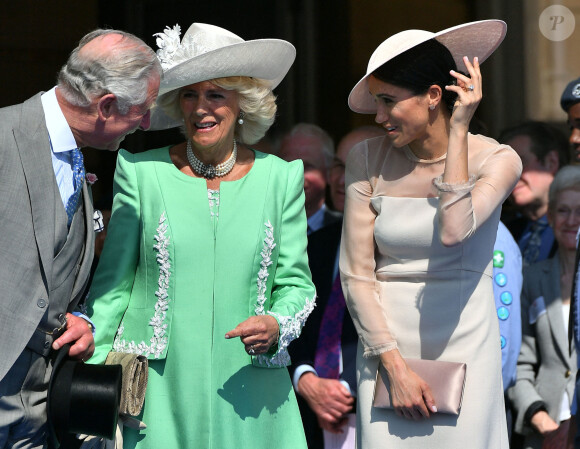 Camilla Parker Bowles, duchesse de Cornouailles, et Meghan Markle, duchesse de Sussex, lors de la garden party pour les 70 ans du prince Charles au palais de Buckingham à Londres. 2018