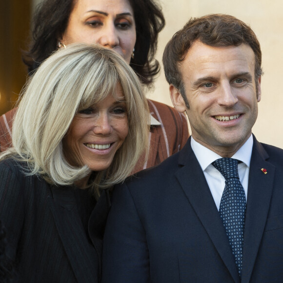 Brigitte et Emmanuel Macron au palais de l'Elysée dans le cadre de la journée internationale des droits des Femmes