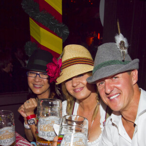 Michelle Yeoh, Michael Schumacher et sa femme Corinna lors de la soiree Oktoberfest a Munich le 1er octobre 2013. (c) Arthur Thill