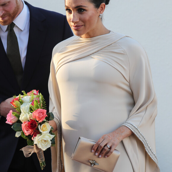 Le prince Harry, duc de Sussex, et Meghan Markle, duchesse de Sussex, enceinte assistent à une réception organisée par l'ambassadeur britannique au Maroc, Thomas Reilly, à la résidence britannique de Rabat, le 24 février 2019, dans le cadre de leur voyage officiel au Maroc. 