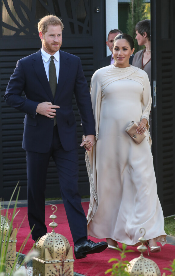 Le prince Harry, duc de Sussex, et Meghan Markle, duchesse de Sussex, enceinte assistent à une réception organisée par l'ambassadeur britannique au Maroc, Thomas Reilly, à la résidence britannique de Rabat, le 24 février 2019, dans le cadre de leur voyage officiel au Maroc. 