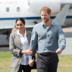 Le prince Harry, duc de Sussex, et Meghan Markle (enceinte), duchesse de Sussex, à leur arrivée à l'aéroport de Dubbo, à l'occasion de leur voyage officiel en Australie.