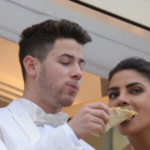 Nick Jonas et sa femme Priyanka Chopra partagent une pizza sur le balcon de l'hôtel Martinez lors du 72ème Festival International du Film de Cannes en France. Les jeunes mariés plaisantent et s'embrassent. Le 18 mai 2019