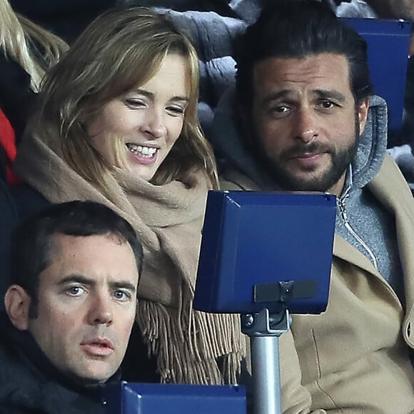 Maxim Nucci et sa compagne Isabelle Ithurburu enceinte assistent au huitième de finale retour de Ligue des Champion, du Paris Saint-Germain contre le Real Madrid au Parc des Princes à Paris le 6 mars 2018. © Cyril Moreau/Bestimage