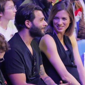 Maxim Nucci (Yodelice) et sa compagne enceinte Isabelle Ithurburu assistent au match de boxe de Tony Yoka au palais des sports de Paris, le 23 juin 2018 © Veeren-CVS/Bestimage