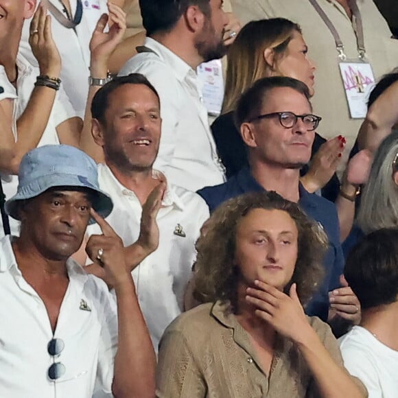 Yannick Noah et son fils Joalukas - People dans les tribunes lord du match d'ouverture de la Coupe du Monde de Rugby France 2023 avant le match de la Poule A entre la France et la Nouvelle-Zélande au Stade de France à Saint-Denis le 8 septembre 2023. © Dominique Jacovides/Bestimage