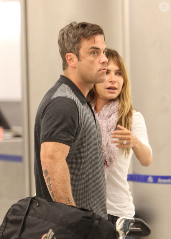 Robbie Williams et Ayda Field à l'aéroport de Miami, le 28 juin 2010