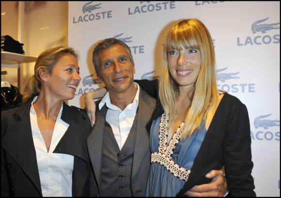 Nagui entouré de sa femme Mélanie Page et d'Anne-Sophie Lapix lors de la soirée d'ouverture de la boutique Lacoste 95 avenue des Champs Elysées à Paris, le 28 avril 2011