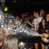 Daniel arrose la foule de champagne aux côtés de Simon et Morgan lors d'une soirée au Duplex le 7 septembre 2011