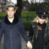 Kate Moss, masquée par sa casquette d'officier, se rend main dans la main avec son mari Jamie Hince visiter sa nouvelle maison. Londres, le 23 novembre 2011.