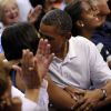 Michelle et Barack Obama assistent à un match de l'équipe olympique féminine de basket contre le Brésil et s'embrassent, à Washington, le 16 juillet 2012